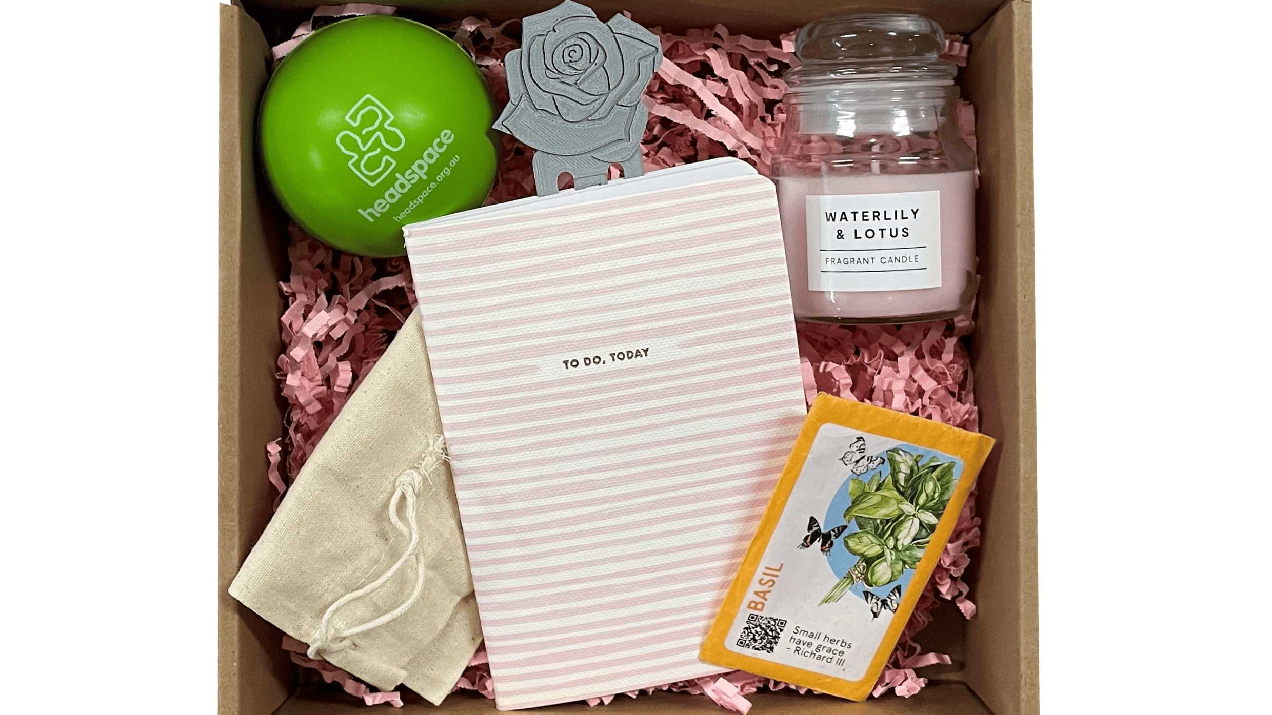 Welcome Kit for the users of Headspace. It includes a stress ball, handmade candle from the candle workshop, to-do notebook, seeds, pen and items created by users from Headspace workshops.