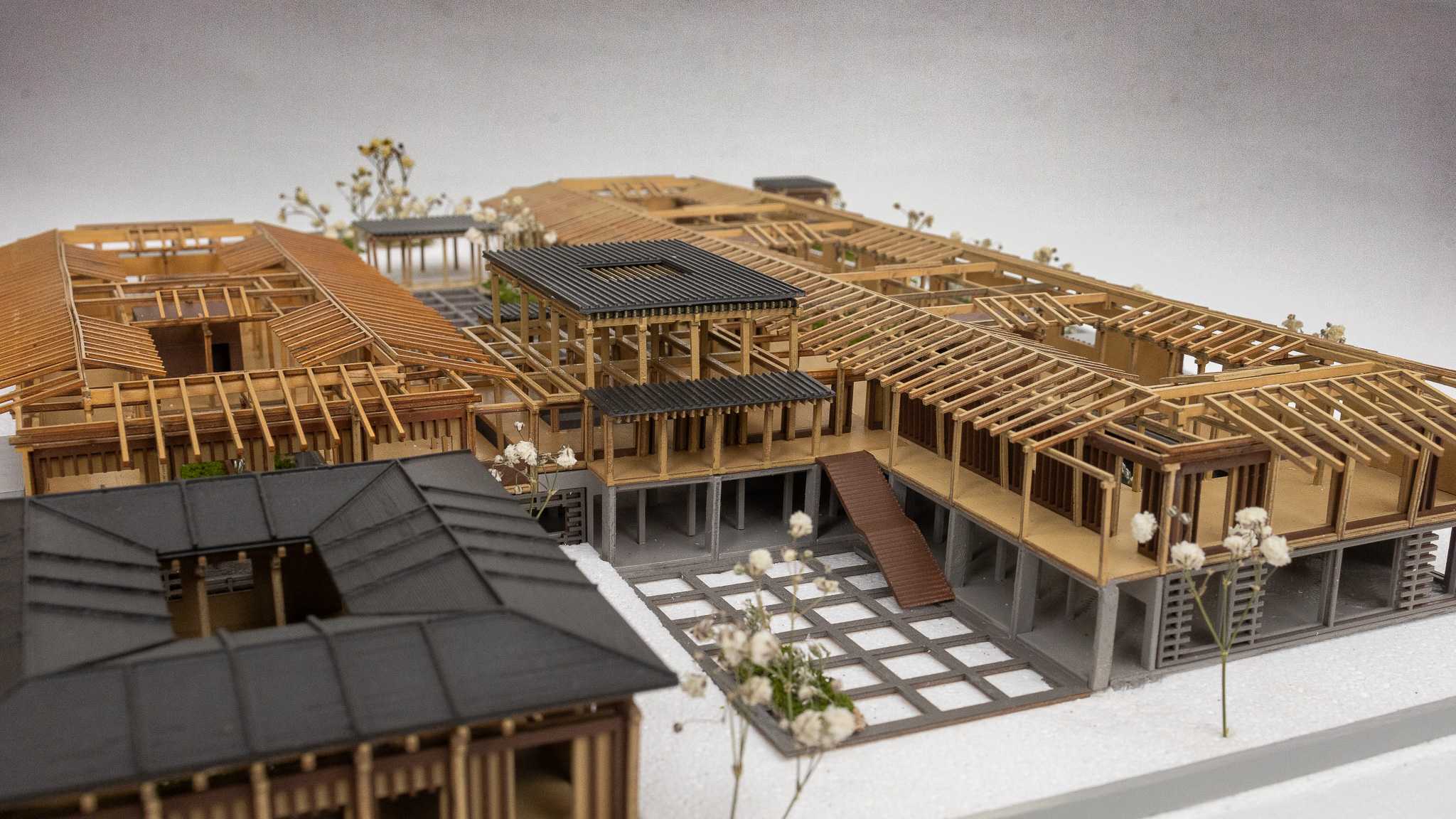 Through deep timber eaves and a contemporary reconstruction of Hanok structure, the space unfolds as a layered landscape of light, shade, and quiet transitions that shape movement and invite reflection.