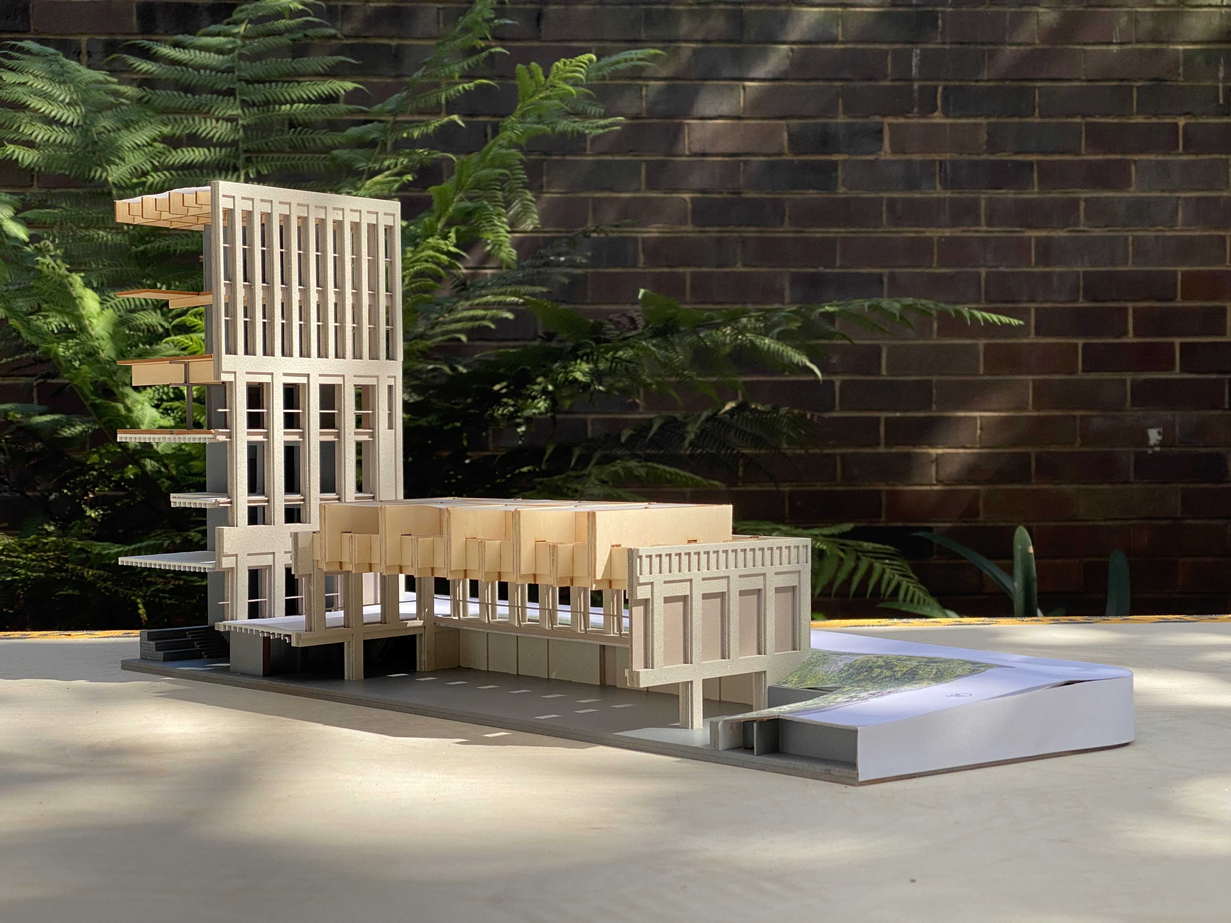 1.100 Sectional scale model photograph displaying the moment of compression that defines the liturgical procession between the sacred and civic spaces.