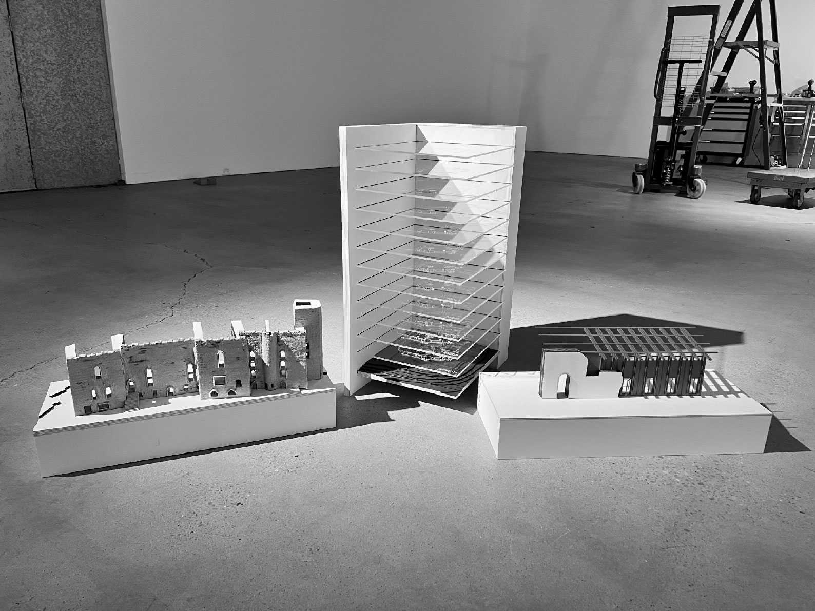Three-part model study showing the existing castle fragment, the palimpsest model tracing its layered histories and the proposed timber intervention reactivating the Kitchen Block.